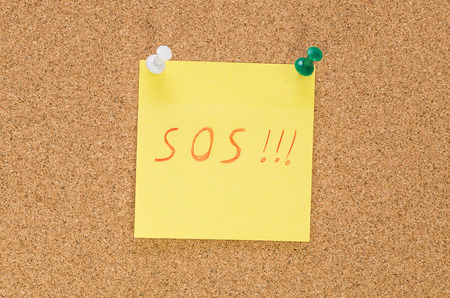 Sos note pinned on the bulletin board