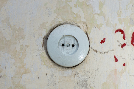 Old electric socket mounted in the wall.の写真素材