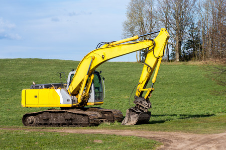 The old excavator stay in the field after worksの写真素材
