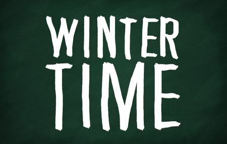 On the blackboard with chalk write Winter timeの写真素材