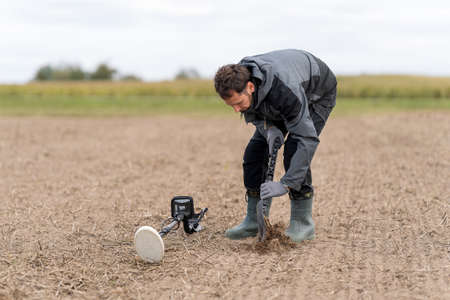 A man is looking for metal with a metal detector.の写真素材