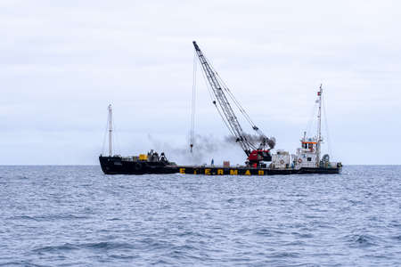 Madeira / Portugal - July 15,  2021.  The industrial ship with workers moored at Madeira coast.