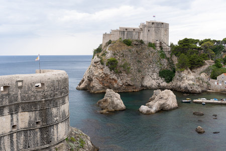 Dubrovnik, Croatia - 8 July 2022: old town city view, old castle view, Ancient fortress view and houses, a castle on the sea bay, hand made walls build with old bricks and stones.のeditorial素材