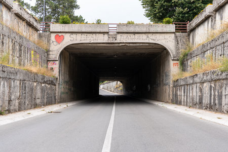 Cetinje, Montenegro - 4 July 2022: dark road tunnel under overpass.のeditorial素材