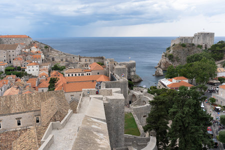 Dubrovnik, Croatia - 8 July 2022: Two sides of city: old town and new town. In the horizont can see old fortres.のeditorial素材