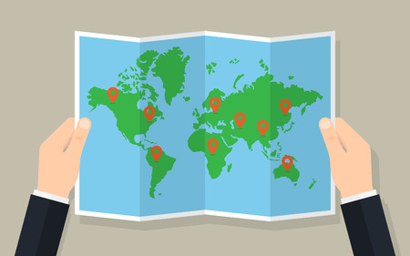 Hands hold folded paper map of world with markers. Vector illustrationのイラスト素材