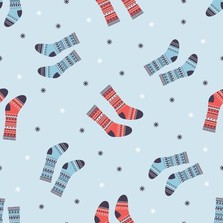 seamless vector new year and christmas pattern in scandinavian simple style, print with traditional festive winter warm clothes different socks on blue backgroundのイラスト素材