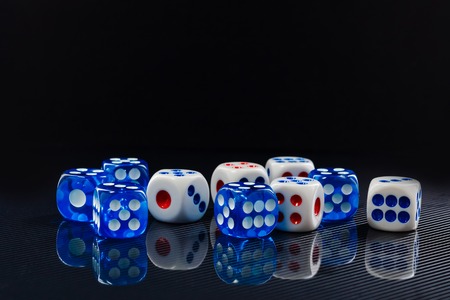 blue and white dices on the glossy black backgroundの写真素材