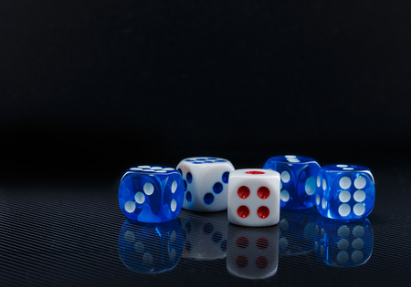blue and white dices on the glossy black backgroundの写真素材