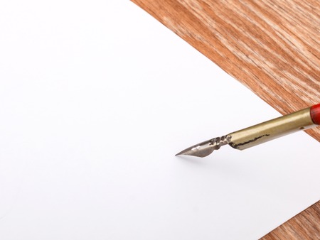 old calligraphy pen on white paper backgroundの写真素材