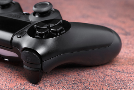 close-up fragment of gamepad on granite surface