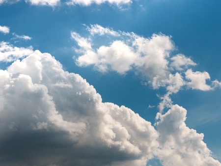 cumulus clouds in deep blue sky