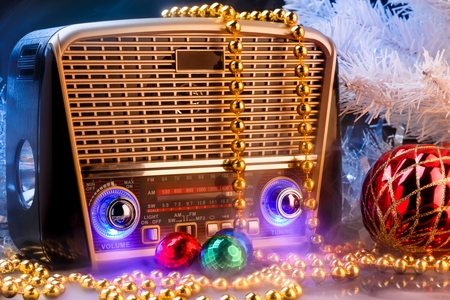 Radio receiver in retro style with christmas decorations on black backgroundの写真素材