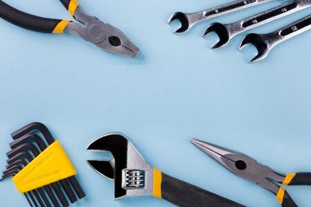 Working tools on blue background. Flat lay.