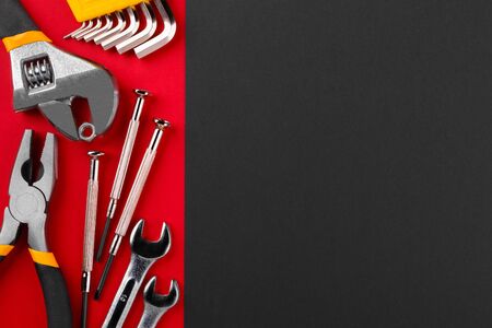 Working tools on red background with copyspace. Flat lay.の写真素材