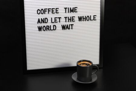 Cup of coffee and a letter board with inscription.の写真素材
