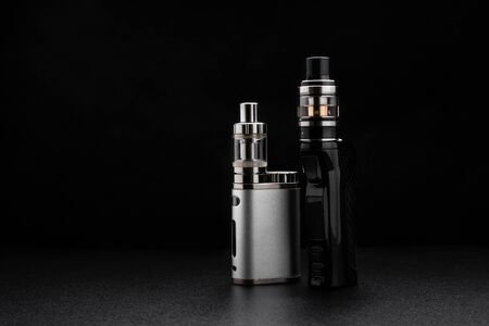 Electronic cigarettes or vaping devices on black