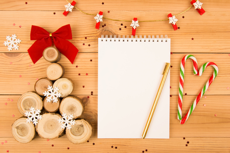 Wooden Christmas tree and notebook.Gold pen.Candy cane.の写真素材