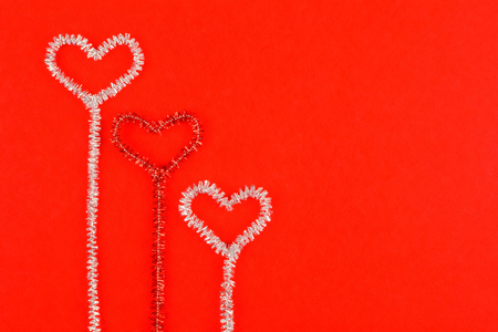 Hearts on a red background.Silver, red, shine.の写真素材