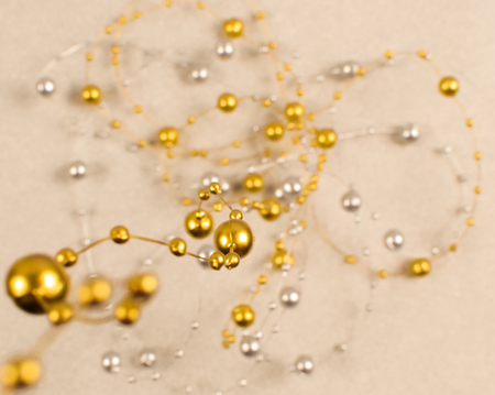 Blurred background of silver and gold beads.の写真素材