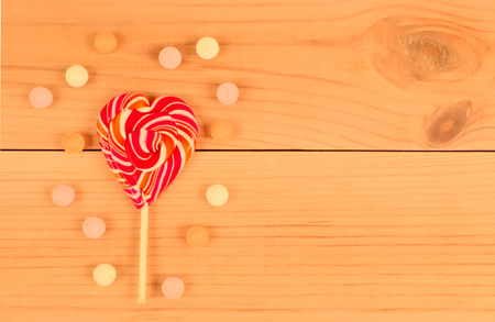 Lollipop on a wooden background with sweets.の写真素材