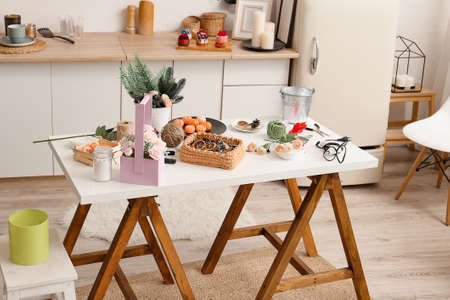 The soap is on the table. Flowers, spruce branches, tangerines, glue gun, bucket, basket, threads,...