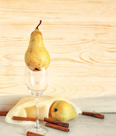 Yellow pearls in a glass on a white wood background. Cooking pearl dessert. Pear is a sweet juicy fruit and a source of vitamins and nutrients.の写真素材
