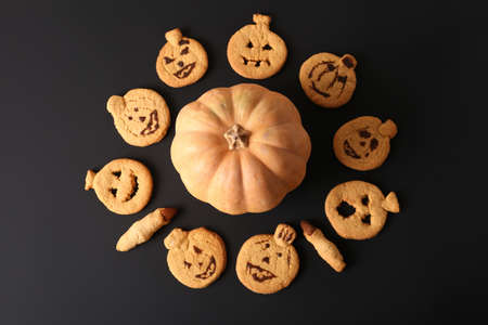 Pumpkin cookies on a black background with place for text. The recipe for fun pastries. Pumpkins and Halloween Cookingの写真素材