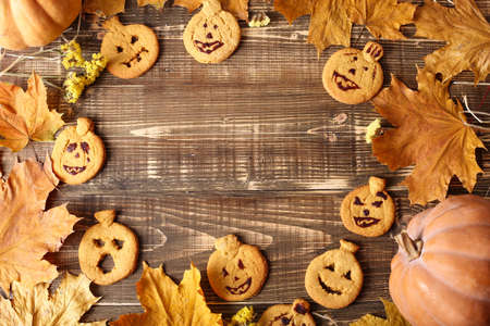 Pumpkin cookies on a dark background with place for text. The recipe for fun pastries. Pumpkins and Halloween Cookingの写真素材