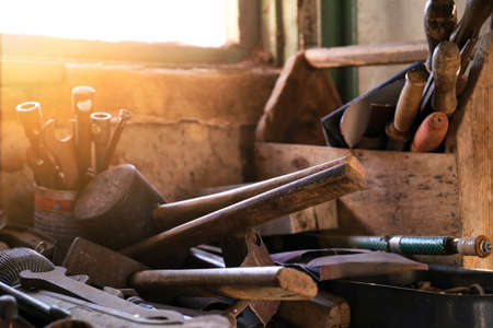 workshop scene. Old tools in workshop, Tool shelf against a table and wall, vintage garage style.