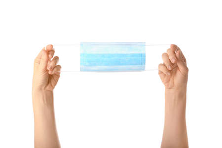 Blue mask in female hands isolated. Antivirus protection tool. Keep the mask close up. Protective medical equipment. Pandemic insurance, airborne diseases, SARS, grippe. concept.の写真素材