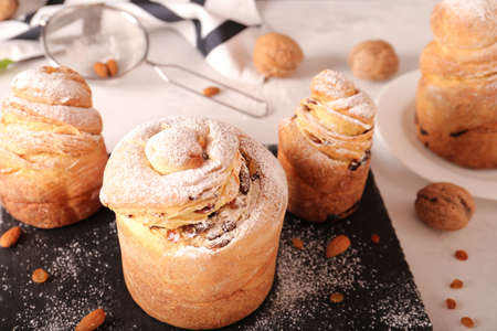 Closeup of homemade easter kraffins with raisins and icing sugar on a cutting board. Homemade holiday cakes kulich kraffin.の写真素材