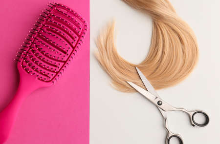 Flat lay composition with light blond hair, comb, scissors and space for text on background. Hairdresser serviceの写真素材