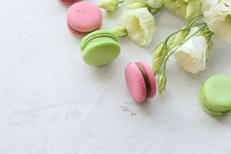 Eustoma and macaroon on a light background. Delicate composition, postcard, congratulations, good morning. Delicious dessert.の写真素材