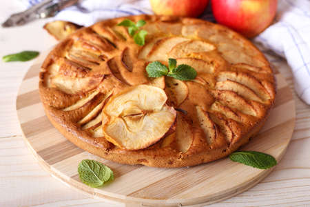 Pie from apples, pears on the table. homemade baking. Tart recipe and preparation. Ingredients for baking. Mint, cinnamon, honey. Beautiful dessert presentation.の写真素材