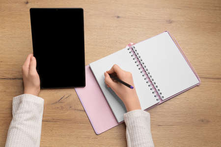 Little girl using Tablet PC at home or kindergarden. Education, science, technology, children and people conceptの写真素材