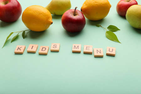 Kid's menu lettering on a light background. Fruit and the need for vitamins. Balanced baby food concept. Food in kindergarten and school. caring for a child. No fast food, fruits instead of sweets. Health benefits of the child.の写真素材