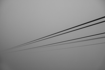 Cables cable car disappearing in the fog. Black and white background.の写真素材