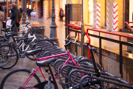Bicycles parked on the sidewalk of the street in the evening after the rain.の写真素材