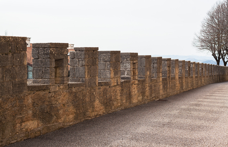 Notched old stone fence and shadow falling from him.の写真素材