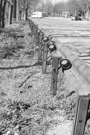 Metal rusty fencing on an empty parking lot in a park zone.の写真素材