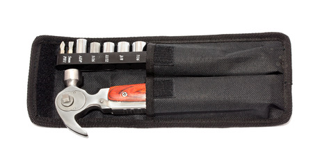Screwdriver for small screws and a hammer in a case close-up. Isolated background.