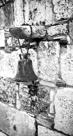 Old little bell hanging on the wall.の写真素材