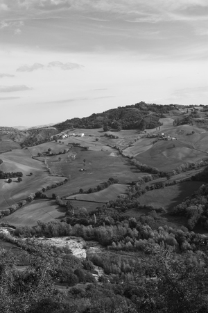 Fields and rarely across houses on hilly terrain in autumn.の写真素材