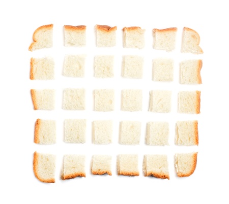 Slice of bread chopped in pieces on white background