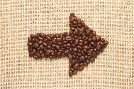 coffee beans arrow on sacking backgroundの写真素材