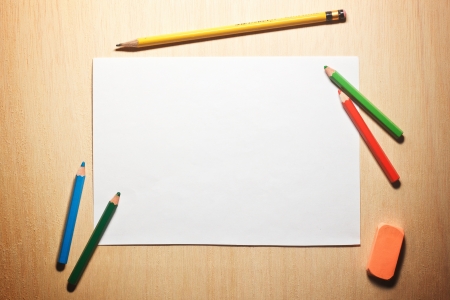 Photo of pencils and blank paper on wooden tableの写真素材