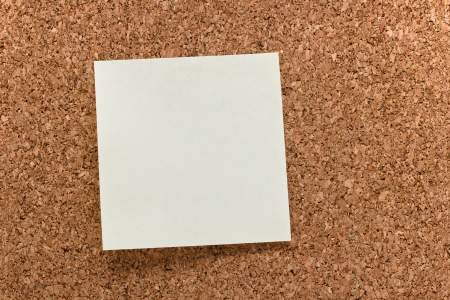 sticky note on a corkboard backgroundの写真素材