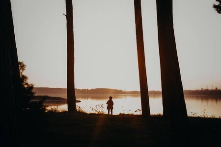 Little boy outdoor on sunset. Beautiful baby portrait with magical mood.の写真素材