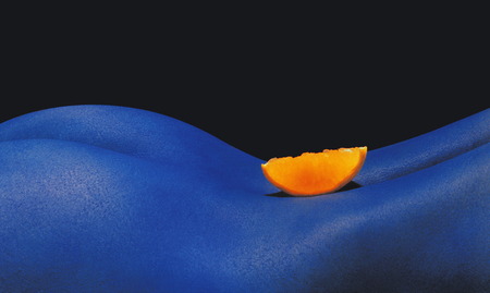 Piece of orange in blue backの写真素材